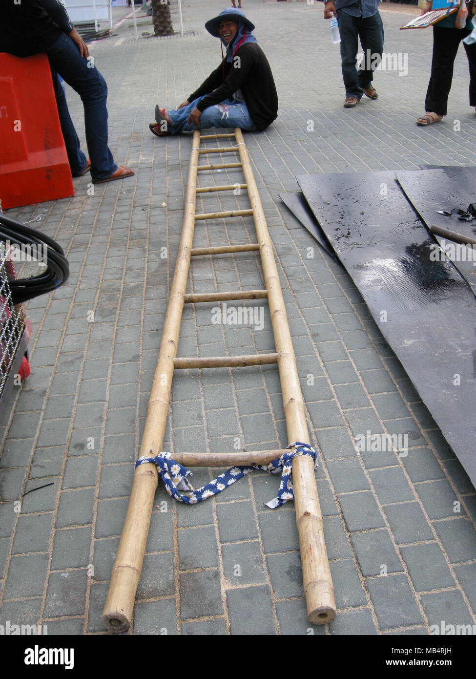 Elektriker und Techniker verwenden Sie 'isolierte' Bambus Leitern auf Freileitungen hier in Pattaya, Thailand zu arbeiten Stockfoto
