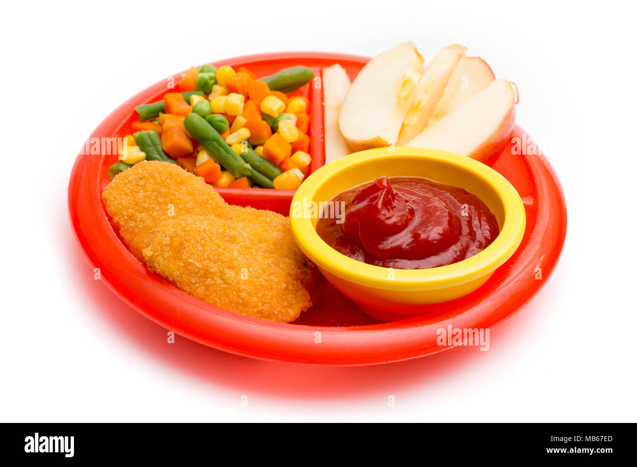 Kinder- Platte mit einer gut ausgewogenen Mahlzeit von Chicken Nuggets, Gemüse in Scheiben geschnitten und Apple Stockfoto