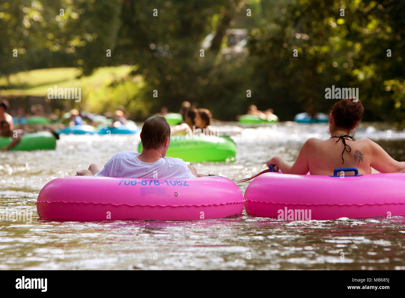 Helen, GA, USA - 24. August 2013: ein Paar genießt die Chattahoochee River Tubing mit Hunderten von anderen in North Georgia an einem warmen Sommertag. Stockfoto