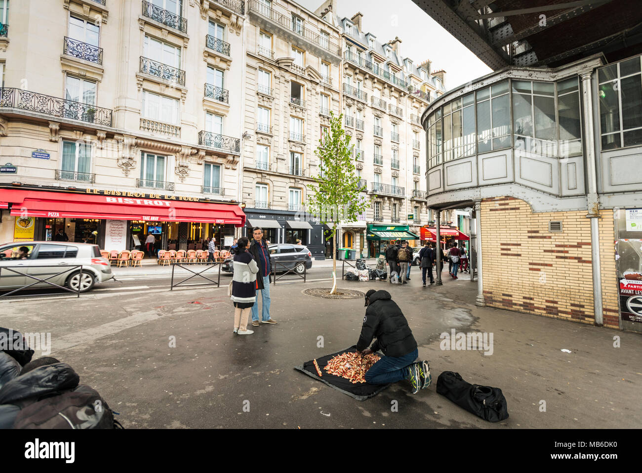 Ein Mann verkauft Waren auf der Straße rund um den Boulevard de Grenelle, ein Summen von Touristen und Pariser und seine kaum 4 Minuten vom Eiffelturm entfernt. Stockfoto