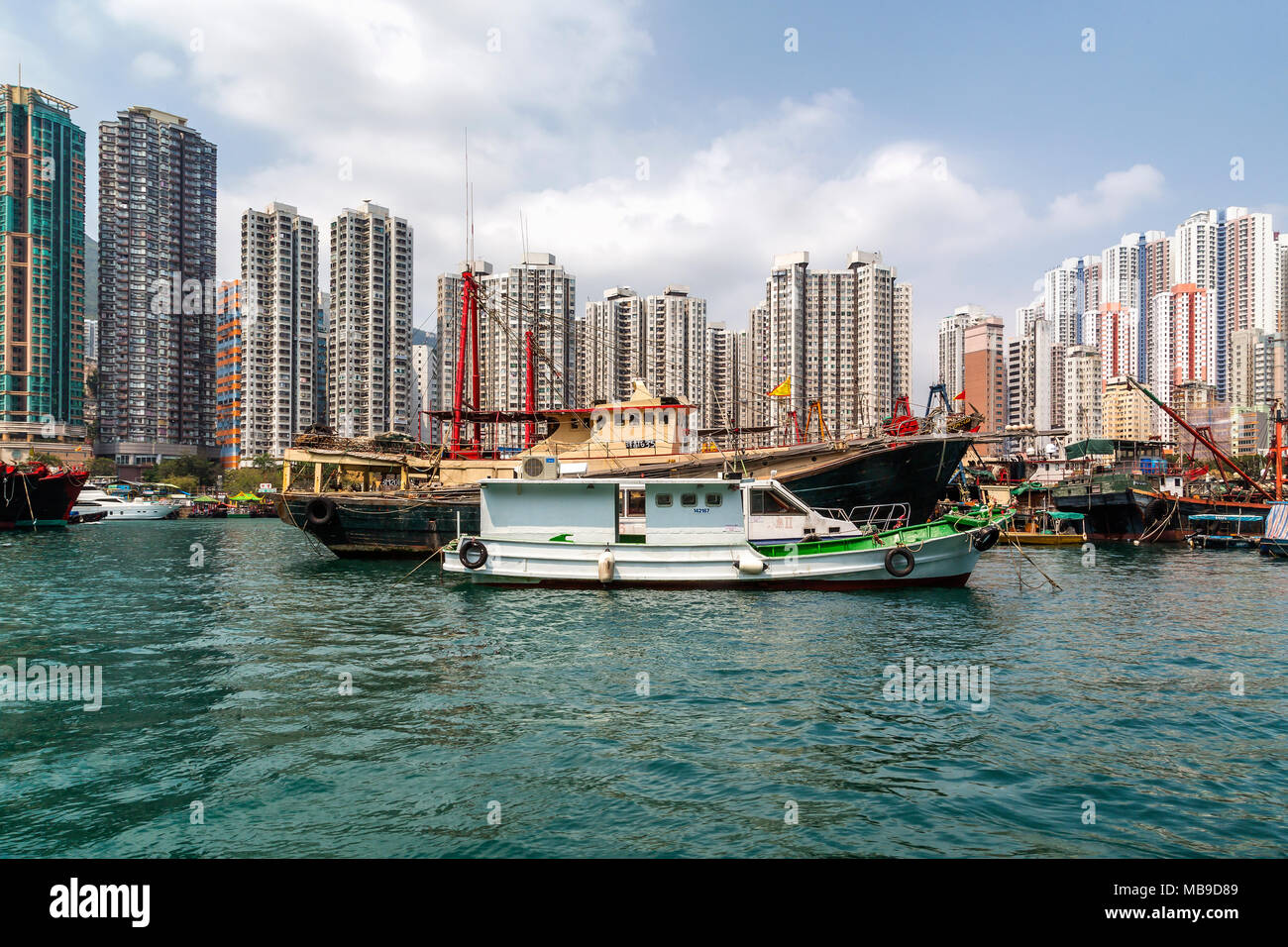 Hohe Gebäude bieten die Kulisse für Fischerboote im Hafen Aberdeen, Hong Kong. Stockfoto