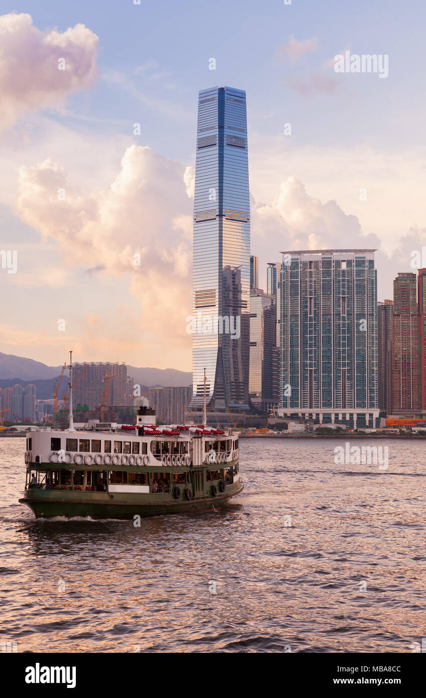 Passagierfähre geht an das International Commerce Center in Hong Kong unter bunten Abend Himmel Stockfoto