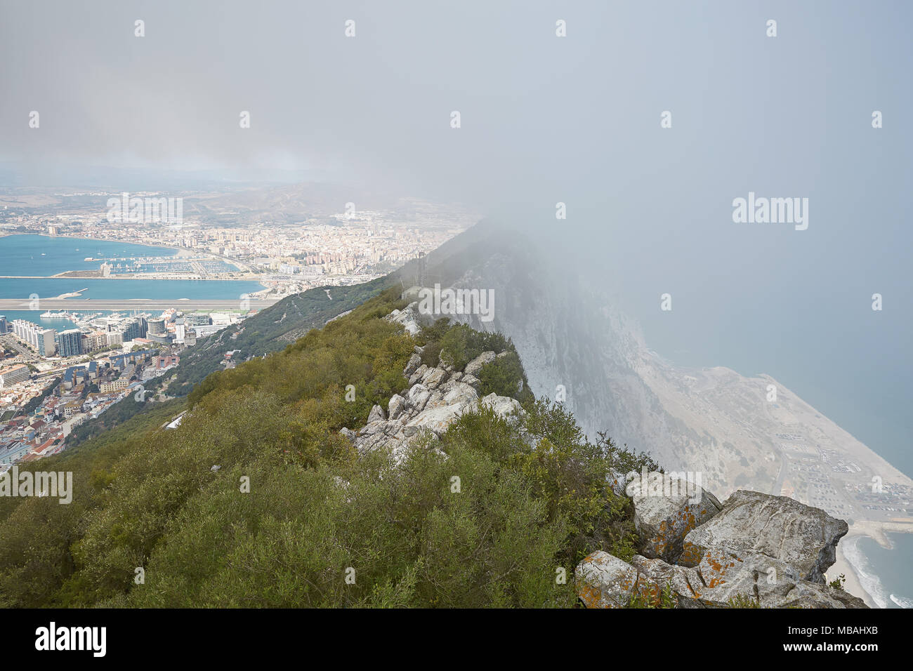 Luftbild von oben von Gibraltar Rock, in Upper Rock Naturpark: Auf der linken Seite Gibraltar Stadt und die Bucht, La Linea Stadt in Spanien am Ende, Medite Stockfoto