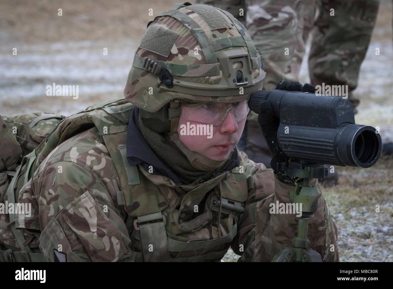 Ein britischer Soldat mit dem leichte Dragoner Peers auf ein Ziel durch den Umfang seiner Spotter in einem Bereich in der Nähe der Bemowo Piskie, Polen, Jan. 15, 2018. Dieser Soldat ist ein Teil der einzigartigen, multinationalen Battle Group aus USA, Großbritannien, Kroatischen und rumänischen Soldaten, die mit der polnischen 15 mechanisierte Brigade als Abschreckung Kraft im Nordosten Polens zur Unterstützung des NATO-Enhanced vorwärts Präsenz dienen. (U.S. Armee Stockfoto