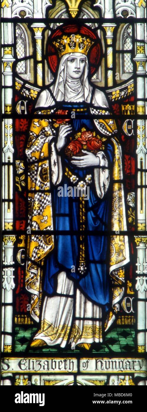 CHRISTIAN - HL. KATHARINA VON UNGARN - Porträt der hl. Katharina von Ungarn mit ihr Blumen. Glasfenster in der Kirche der Hl. Maria in Godstone, Surrey Stockfoto