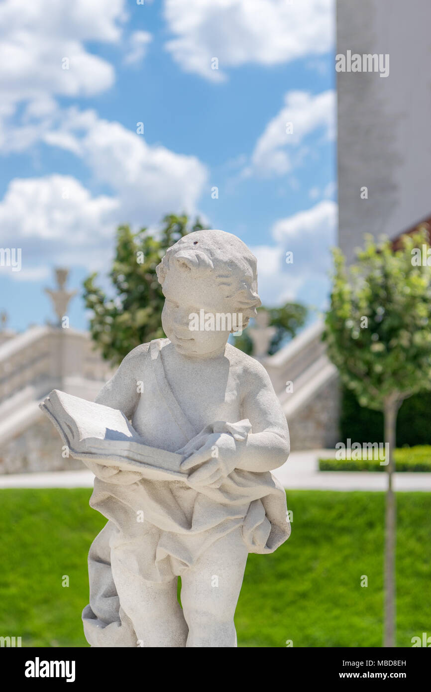 Weiße Statue eines Kindes lesen Bücher Stockfoto