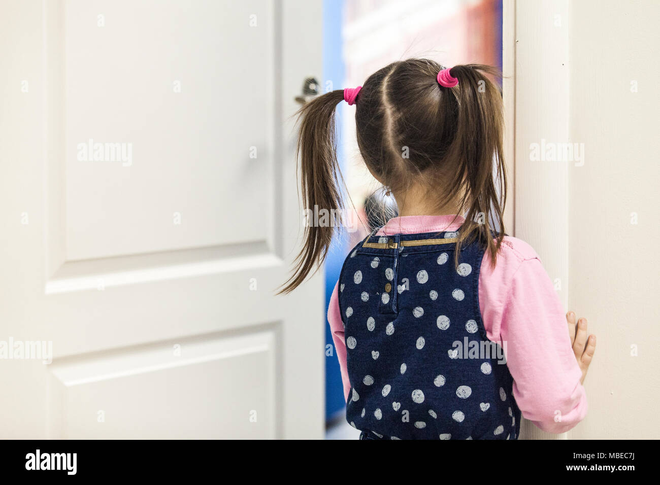 Mädchen (5-7) suchen in Klassenzimmer durch die Tür hinten Stockfoto