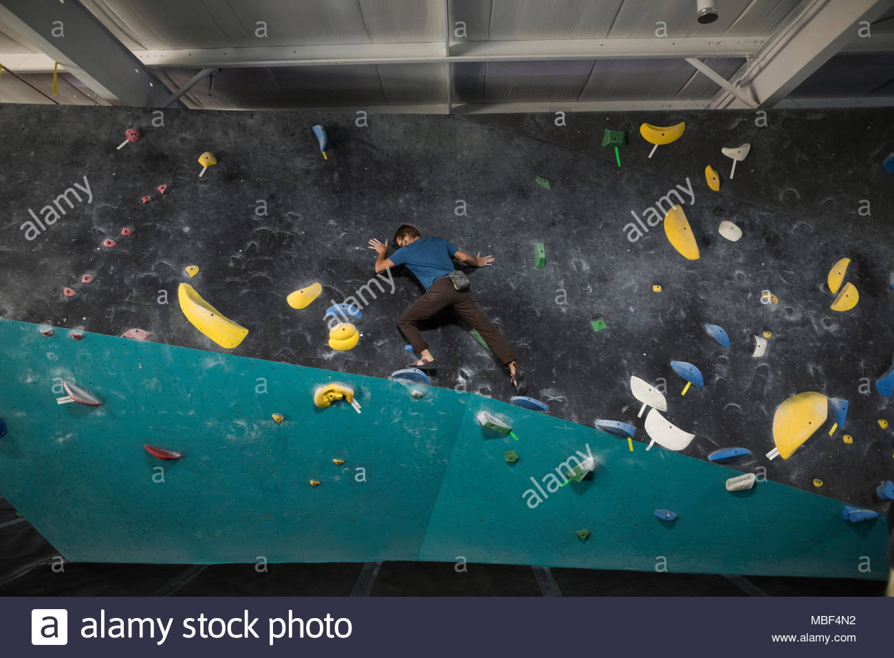Reife männliche Kletterer kletterwand an der Kletterhalle Stockfoto