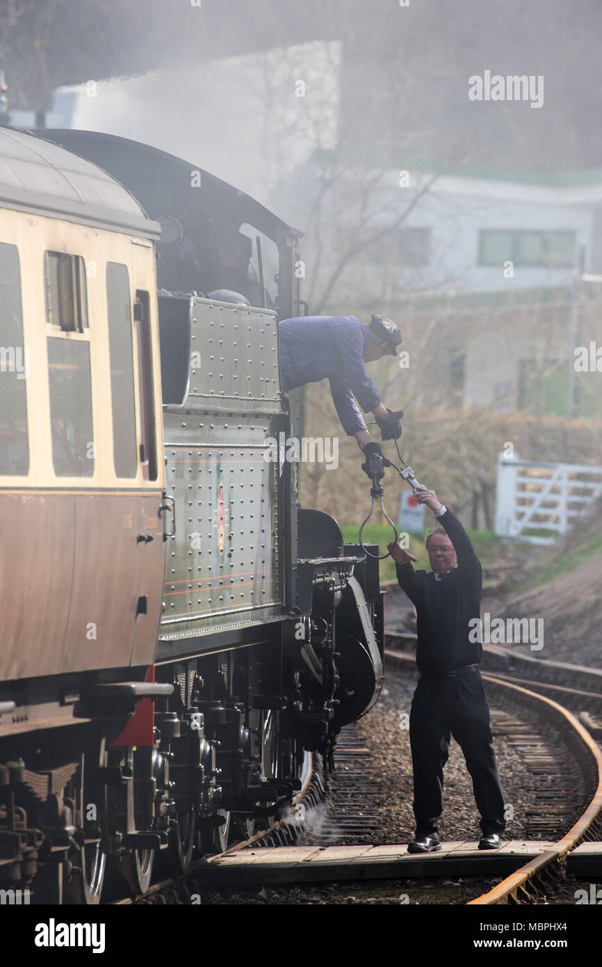 Action shot of Token Exchange, between Steam Engine Crew fireman & Station signalman, taking place on Severn Valley Railway Heritage Line, Highley, UK. Stockfoto