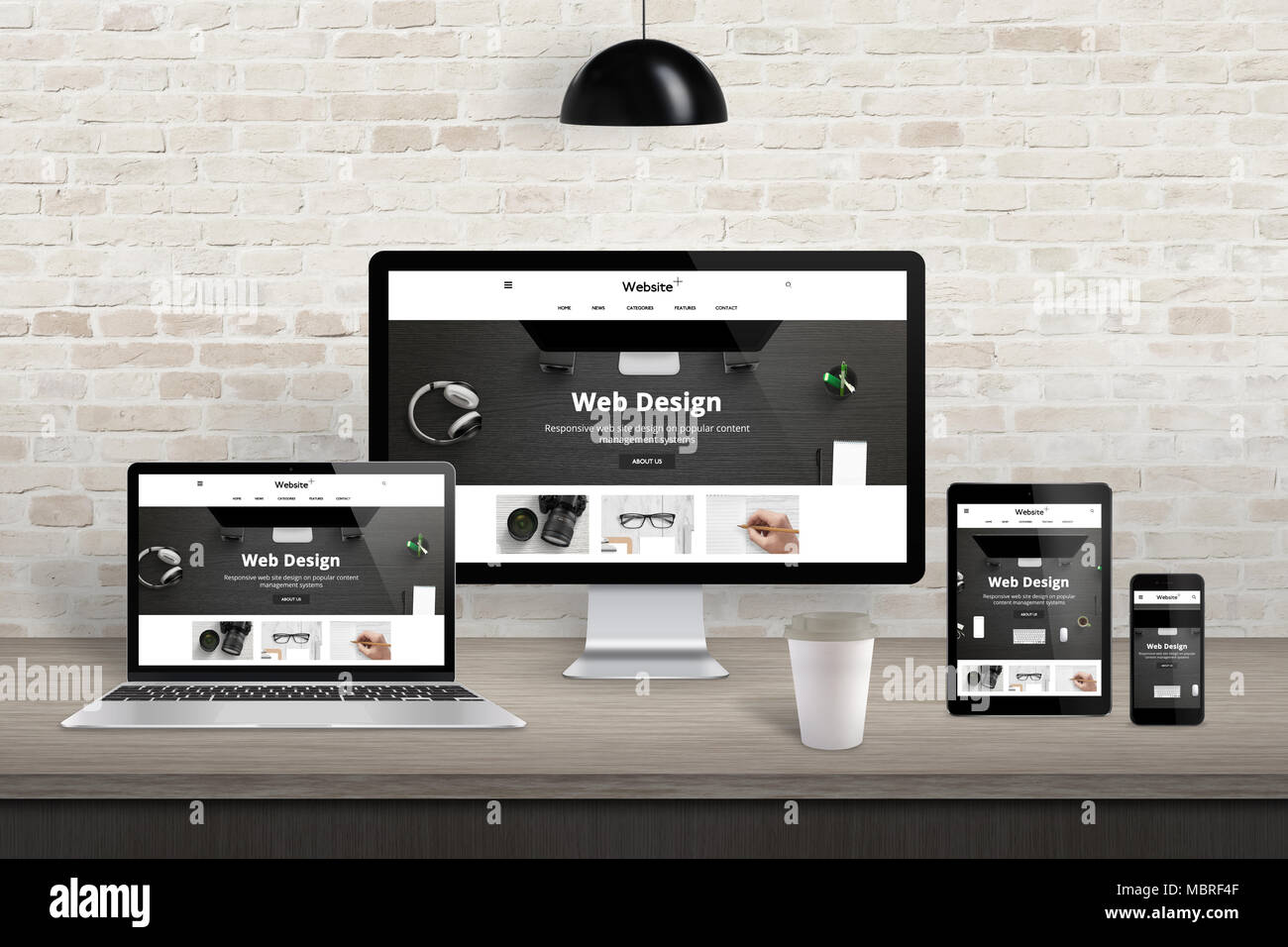 Reaktionsschnelle Website Präsentation auf unterschiedliche Anzeigegeräte. Modernes Studio Interieur. Mauer im Hintergrund. Stockfoto