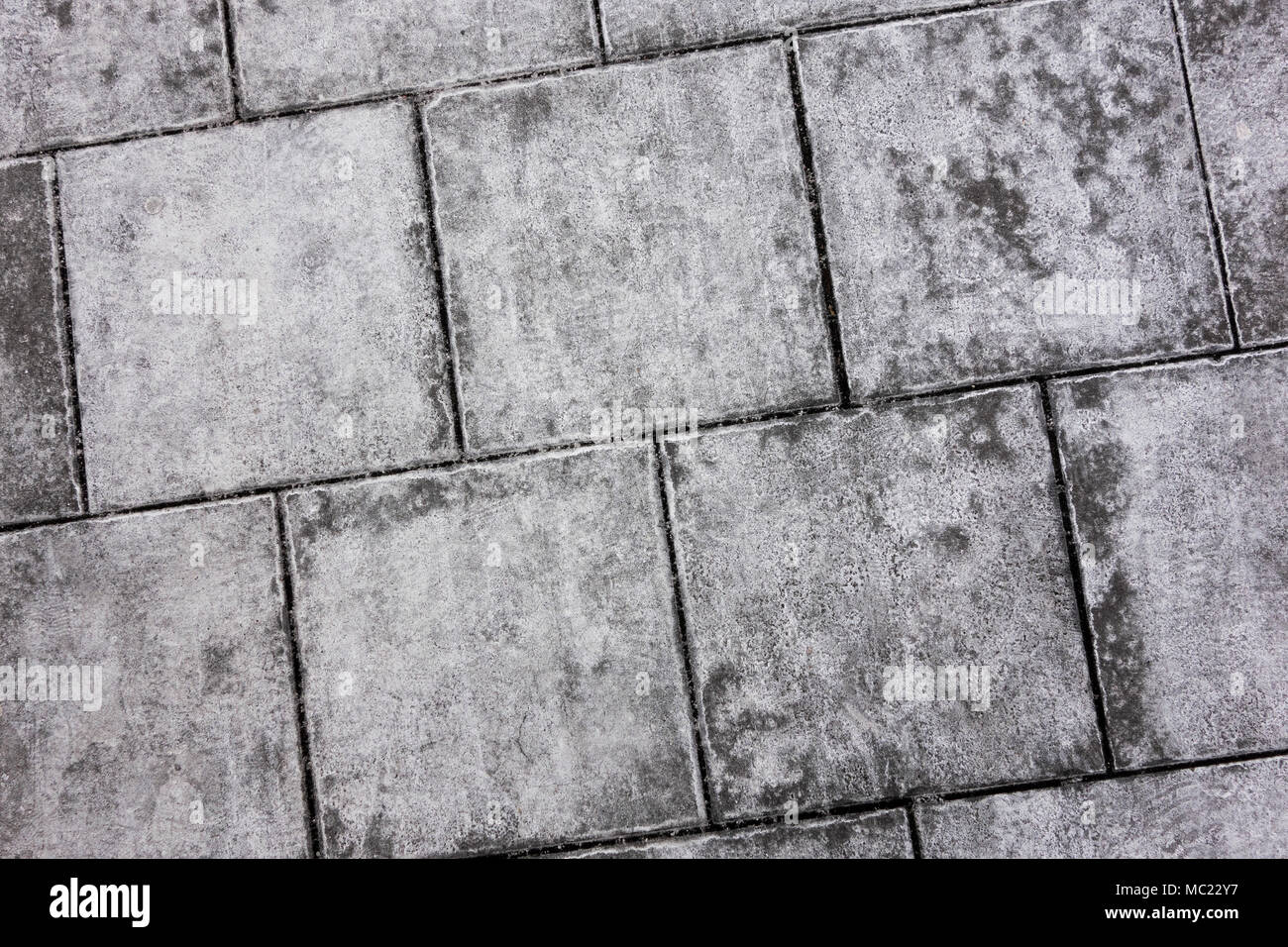 Konkrete gepflasterten Gehsteig Textur im Winter, close-up. Stockfoto