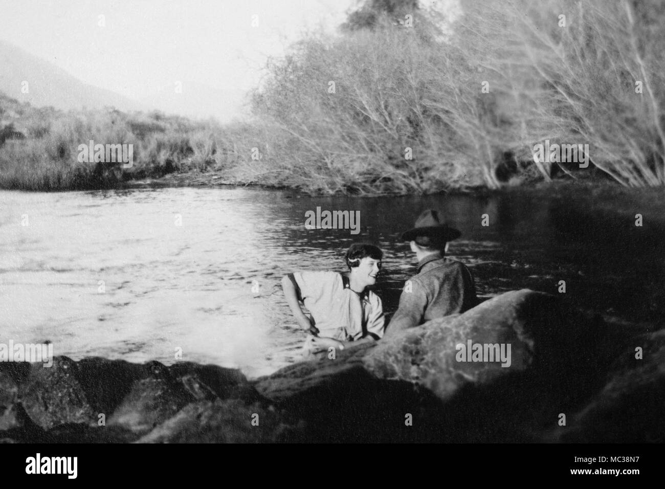 Ein Weltkrieg ära US-Soldat frolics mit seiner Freundin zusammen einige Fluss Felsen auf ein Datum, Ca. 1918. Stockfoto
