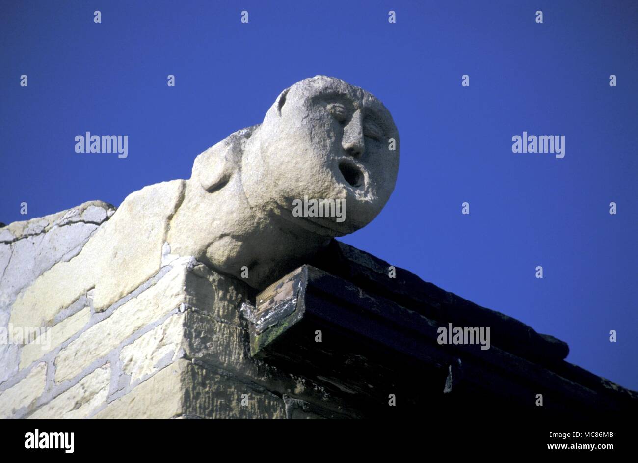 CELTIC Kopf einer der sogenannten "keltischen Köpfe" (lokal namens "Bradford Köpfe") als Schutz- oder amuletic Statuen auf dem Dach eines Hauses in West Lane, Haworth Stockfoto