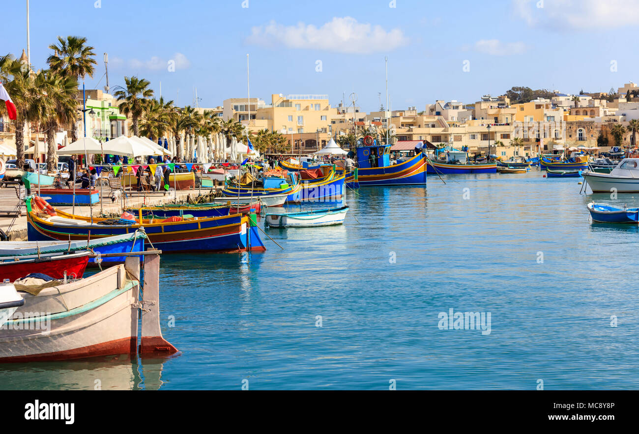 Marsaxlokk, Malta Insel. Traditionelle Fischerboote luzzus mit hellen Farben verankert im Hafen von Marsaxlokk Stockfoto