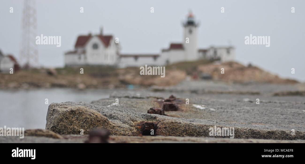 Jetty in Neu-england mit roten und weißen Leuchtturm im Hintergrund von New England Stockfoto