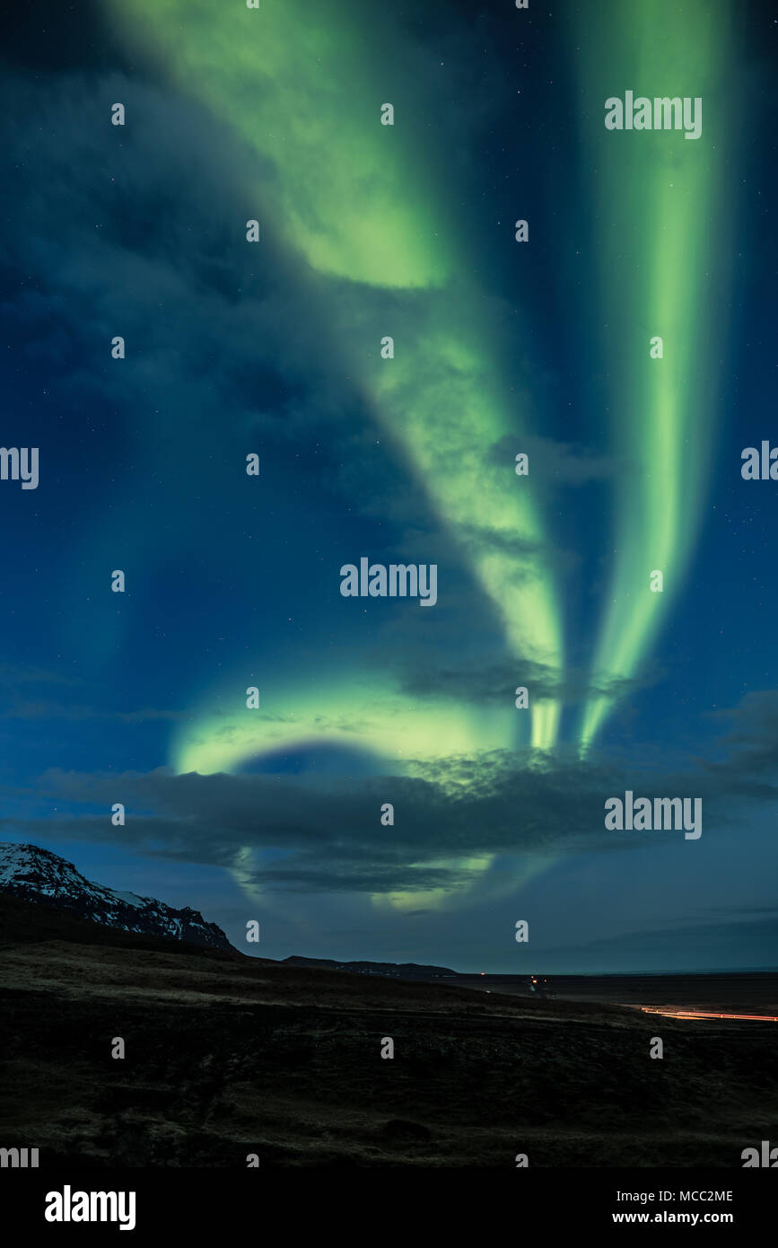 Northern Lights aka Aurora Borealis am Himmel mit Bergen in Island glühende Stockfoto