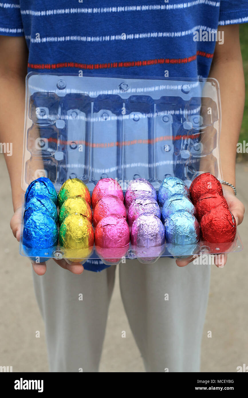 Hand bunte Schokoladeneier auf Kunststoff Karton Stockfoto