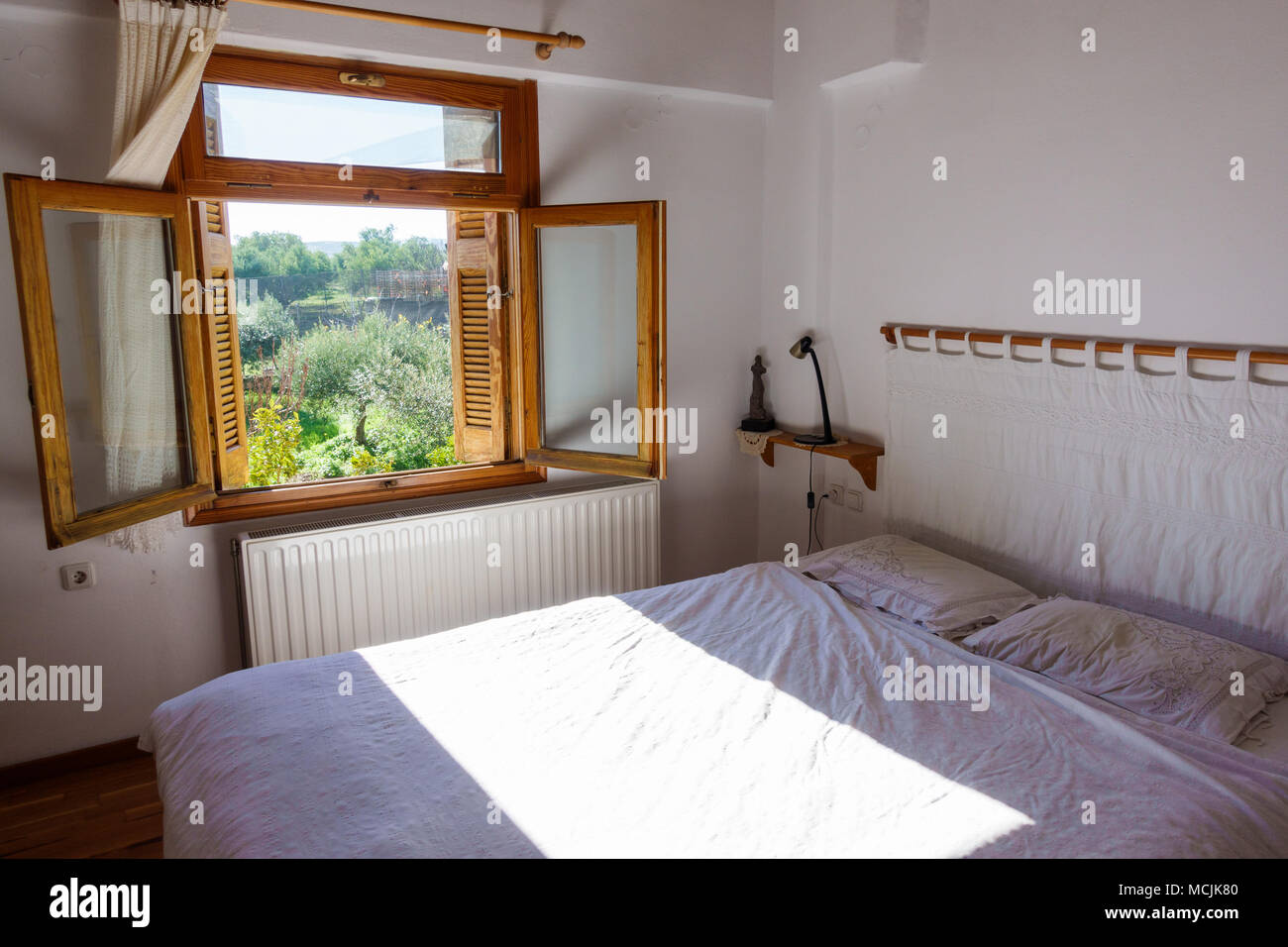Blick auf ein Schlafzimmer mit geöffneten Fenstern, Griechenland Stockfoto