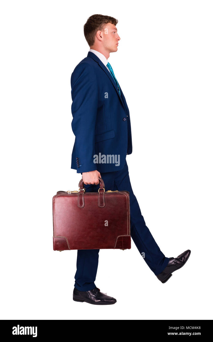 Unternehmer im feinen Anzug mit einer Hand Koffer, Wandern auf der rechten Seite. Stockfoto