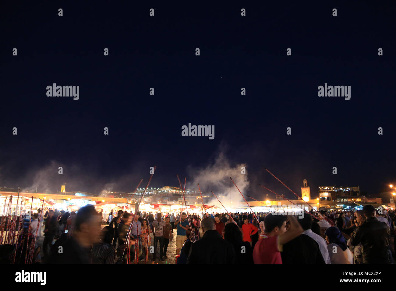 Menschen fischen mit Holzstäbchen für Plastikflaschen auf dem berühmten Platz Djemaa el-Fnaa Platz in Marrakesch, Marokko Stockfoto