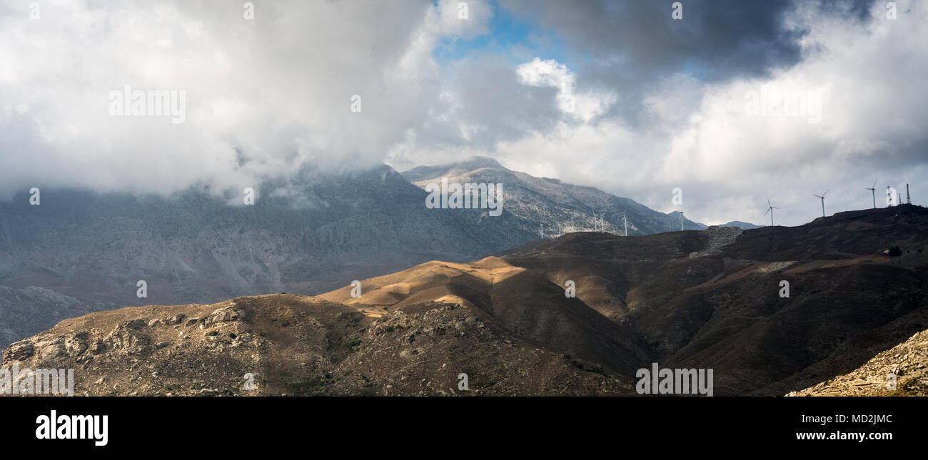 Malerische Aussicht von Windenergieanlagen auf Bergwelt gegen bewölkter Himmel, Kreta, Griechenland Stockfoto