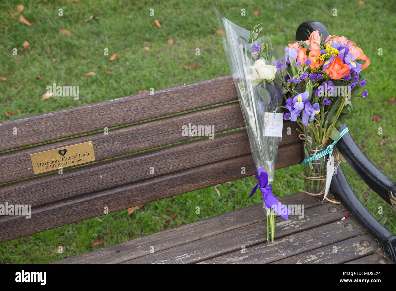Blumensträuße links auf einer Parkbank in Clissold Park, Stoke Newington, in Erinnerung an einen Teenager, der sein Leben nach leiden unter Depressionen. Stockfoto
