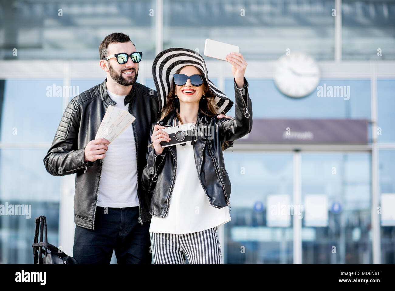 Junges Paar von Reisenden in Lederjacken, selfie Foto stehen vor der Ankunftshalle des Flughafens. Stockfoto
