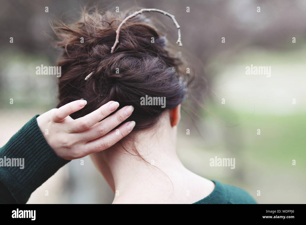 Frau, indem Sie Ihr Haar mit einem Zweig Stockfoto