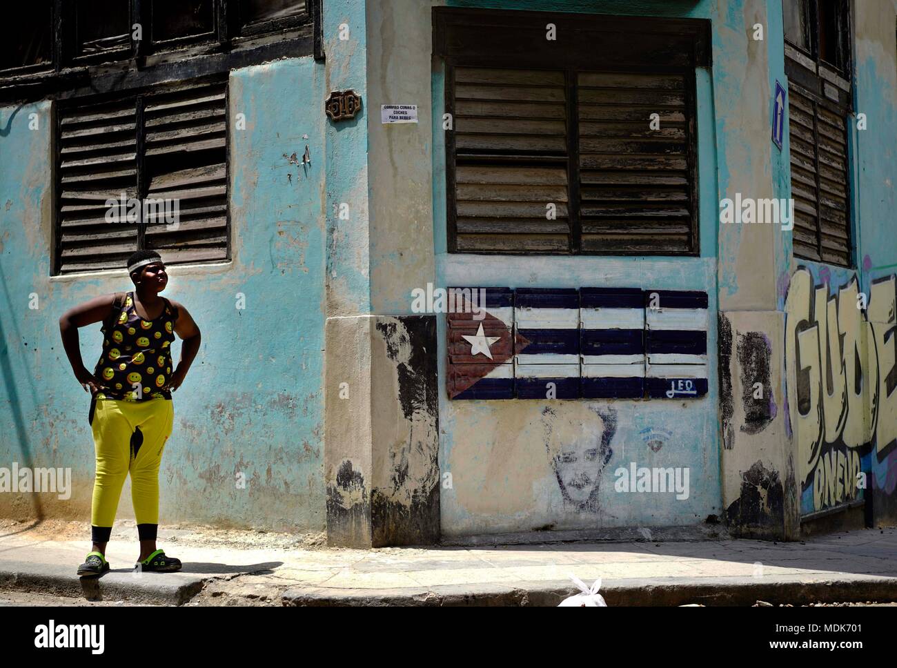 19 April 2018, Kuba, Havanna: Ein Junge steht außerhalb ein Haus, dessen Fassade zeigt die kubanische Flagge. Kuba's New Leader Miguel Diaz-Canel ist der erste Führer nicht den Namen Castro in 60 Jahren zu tragen. Foto: Eliana Aponte/dpa Stockfoto