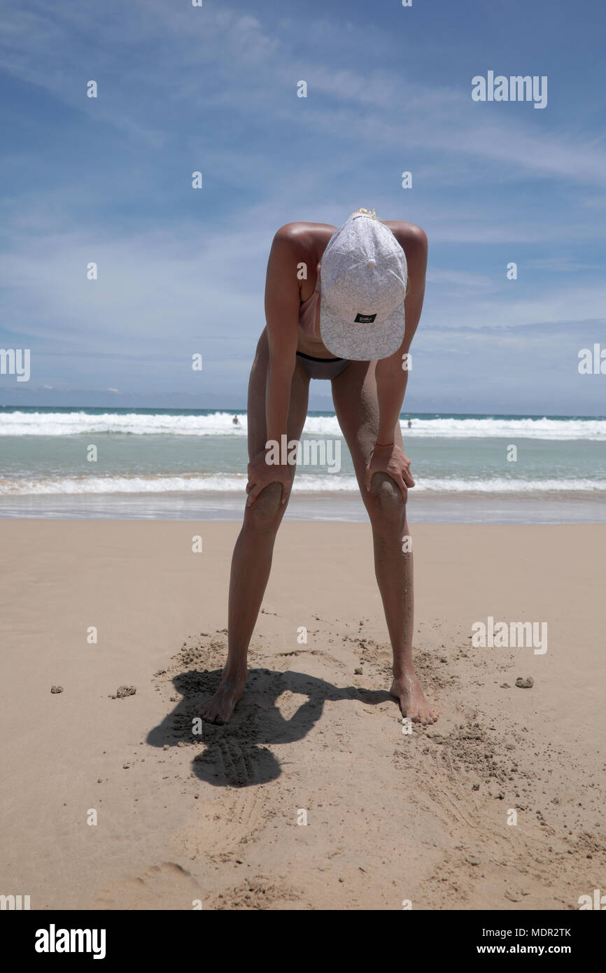 Mirissa/Sri Lanka - April 9, 2018: Müde fitness Frau am Strand nach dem Workout. Stockfoto