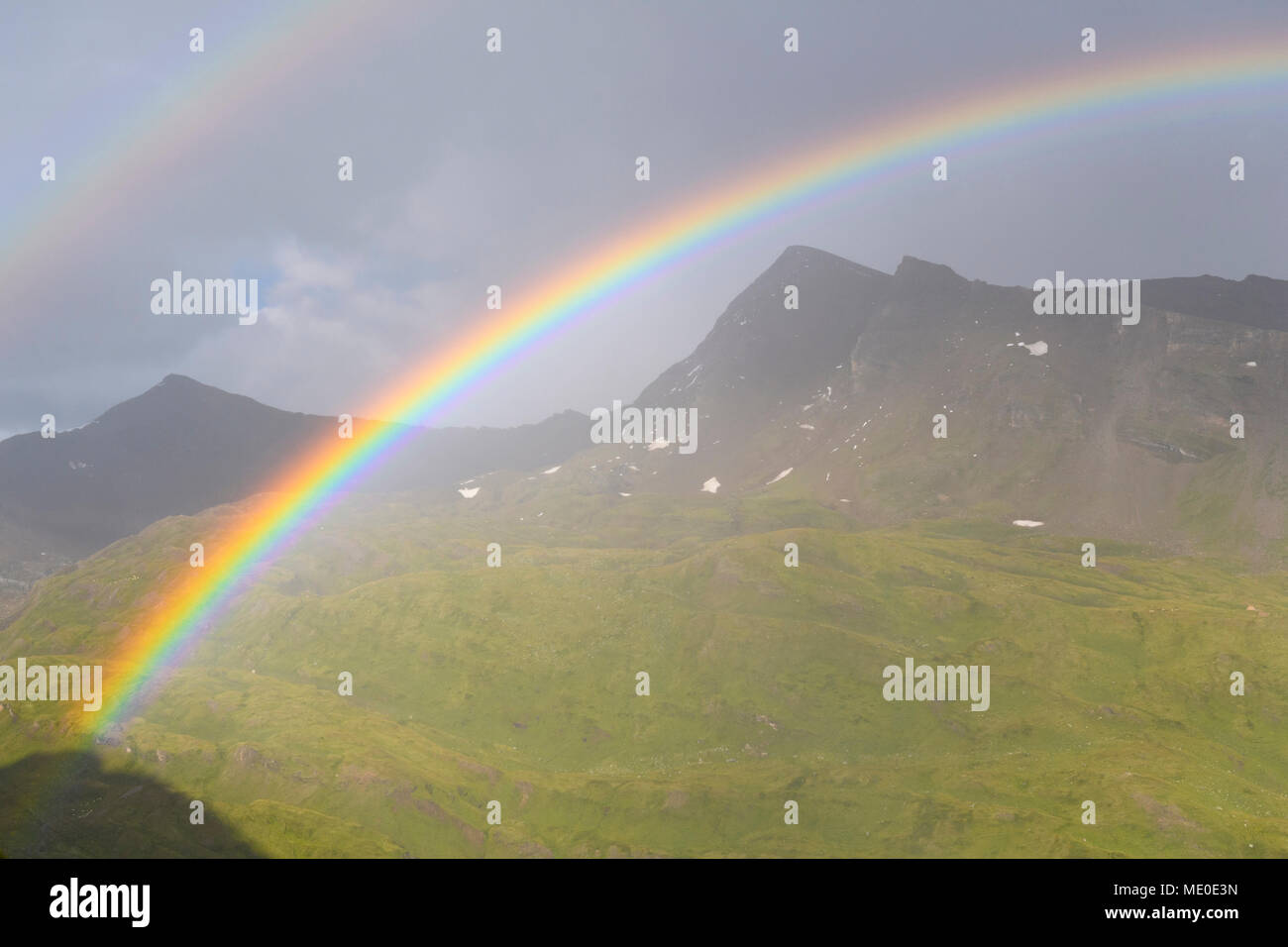 Regenbogen über Berglandschaft bei Kaiser Franz Josefs Hohe im Nationalpark Hohe Tauern in Kärnten, Österreich Stockfoto