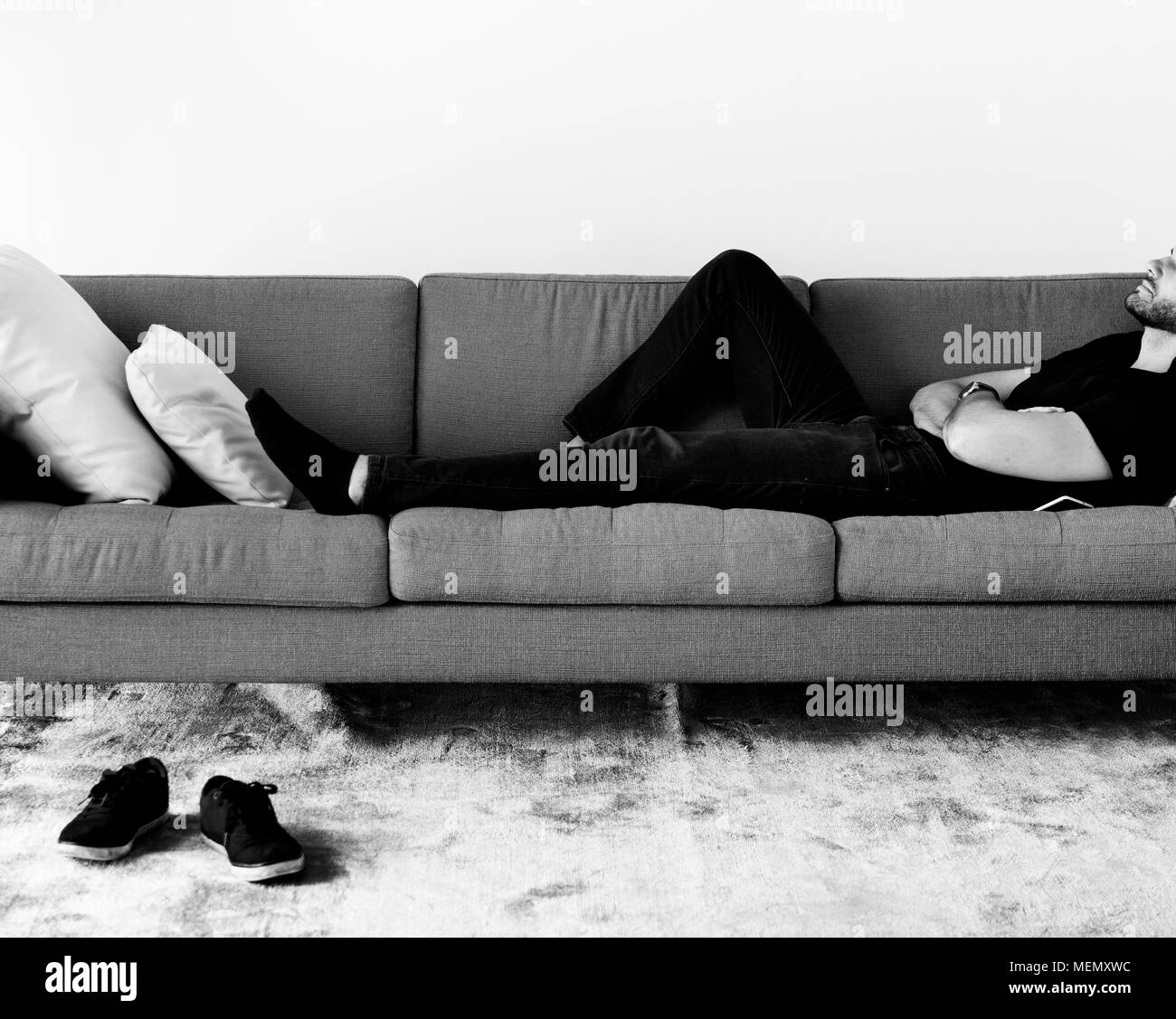 Man schläft auf dem Sofa Stockfoto