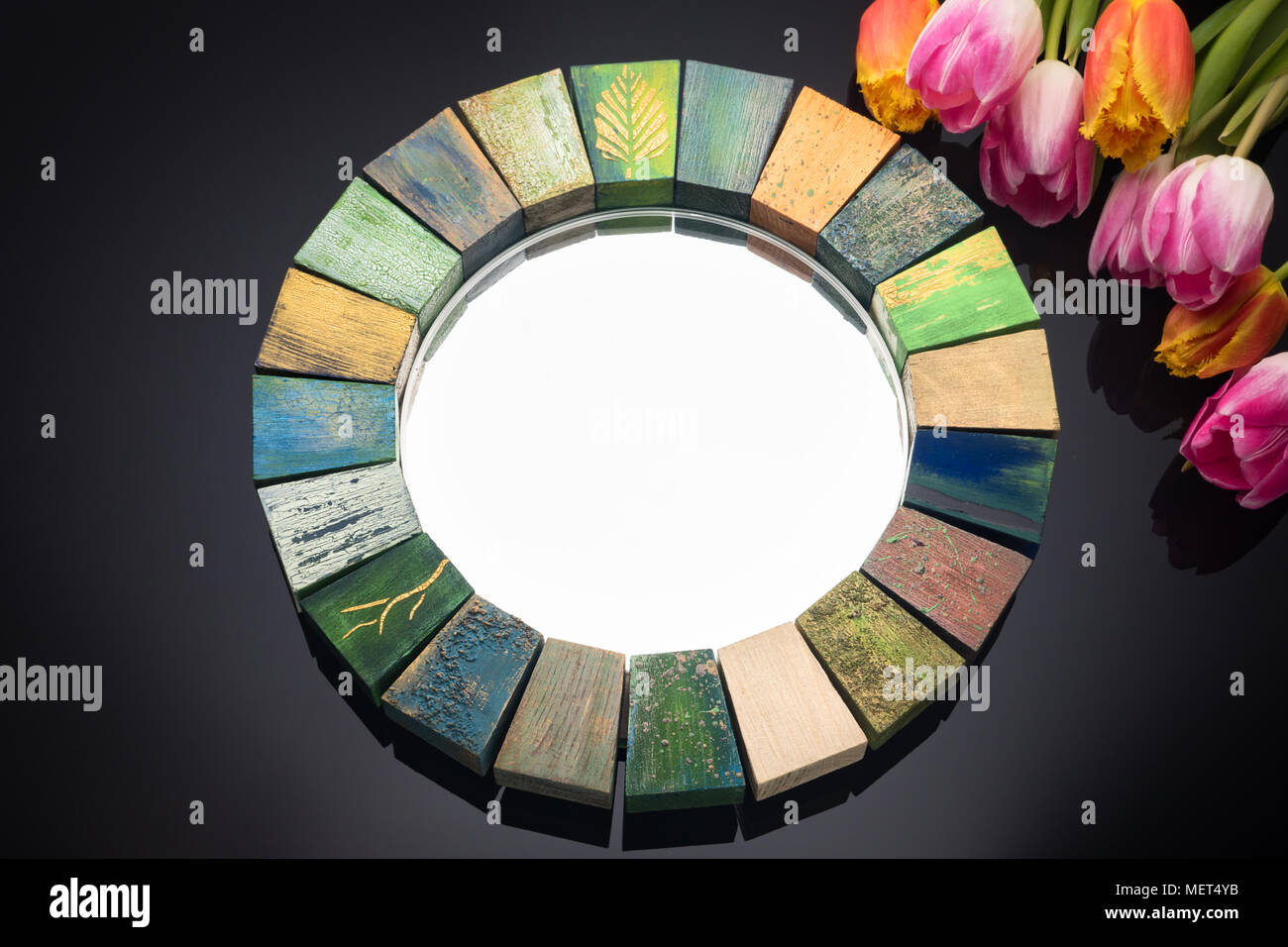 Interior Design Spiegel handgefertigt in Holzrahmen mit gemalten Risse im Alter von Lacken für Make-up der Frauen auf schwarzem Hintergrund und einen Blumenstrauß der Frühling Tulpen Stockfoto