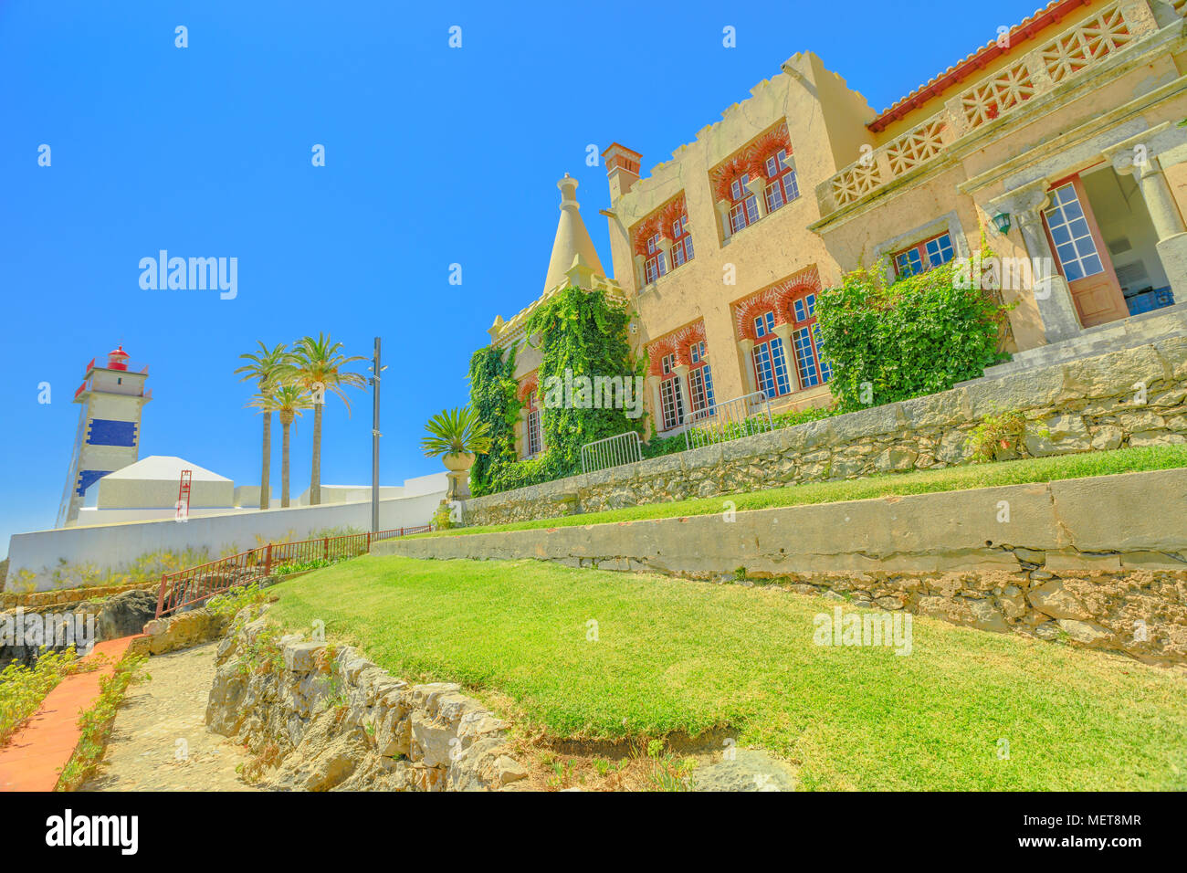 Perspektivische Ansicht von Santa Marta Leuchtturm oder St. Martha's Leuchtturm und Haus der Heiligen Maria oder Casa de Santa Maria in Cascais, Atlantikküste, Portugal. Stockfoto