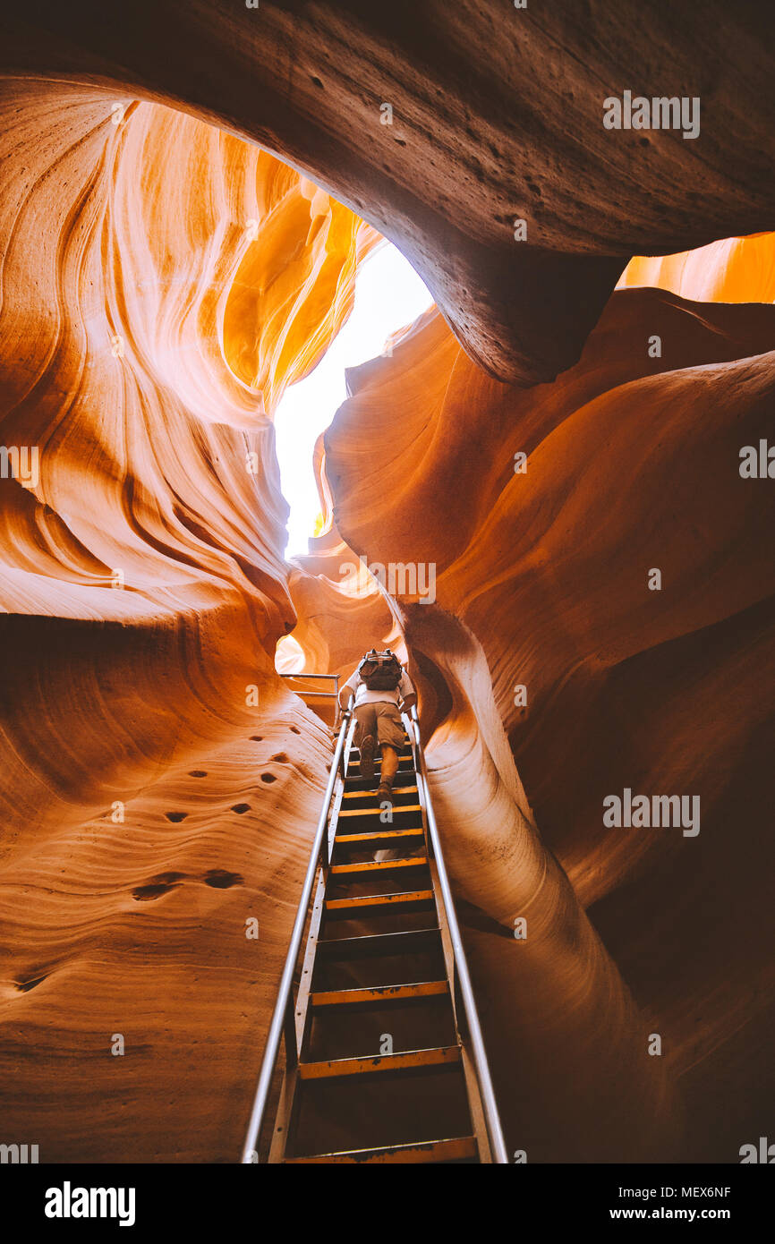 Erstaunlich Sandsteinformationen mit Wanderer aufsteigend eine steile Leiter im berühmten Antelope Canyon an einem sonnigen Tag in der Nähe der Altstadt von Page, Arizona, USA Stockfoto