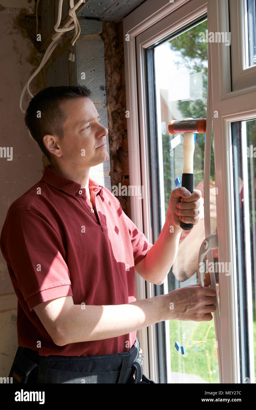 Bauarbeiter im Haus neue Windows-Installation Stockfoto