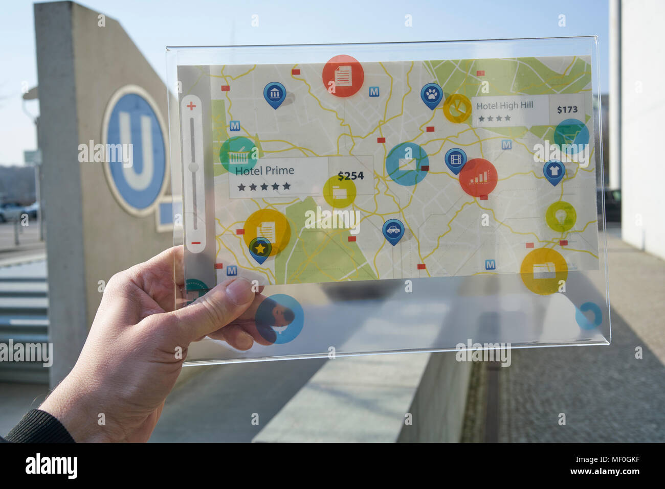 Hand, die futuristische Gerät mit digitalen Symbole und Karte in der Stadt Stockfoto