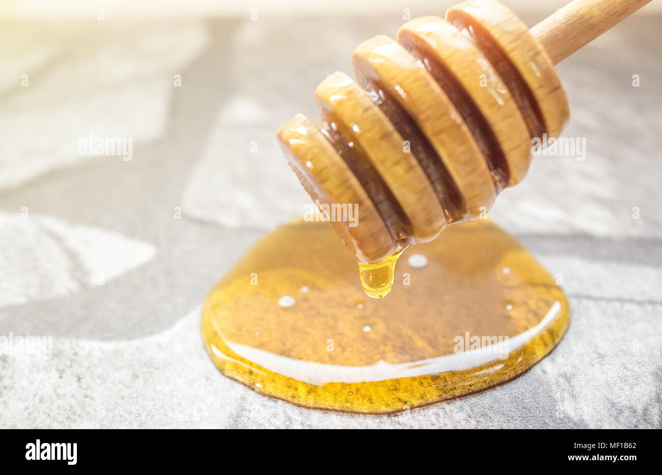 Honig spill Drop und Honig - Löffel auf den Küchentisch Stockfoto