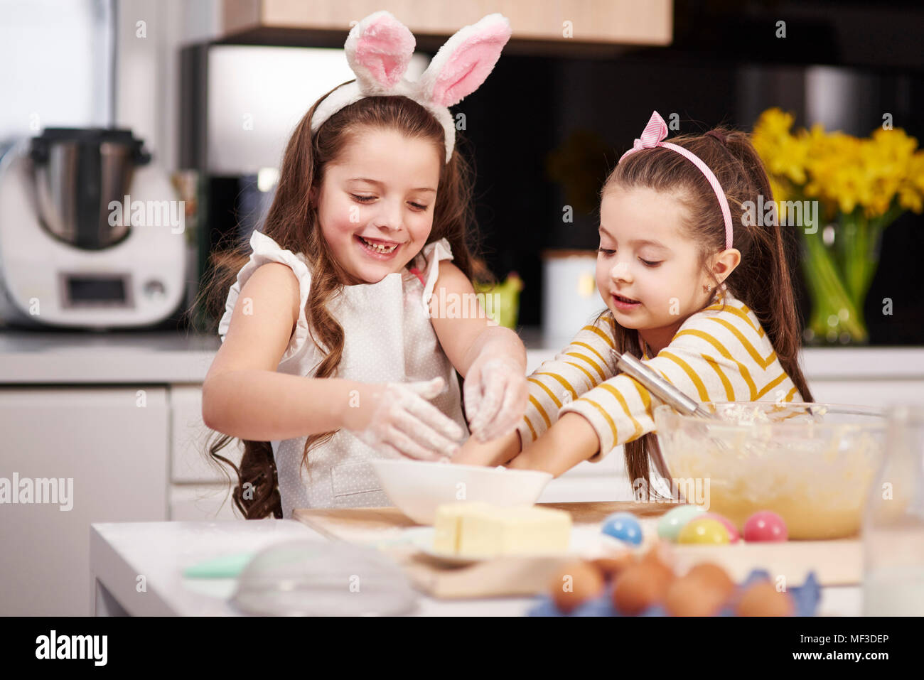 Zwei Schwestern gemeinsam Spaß backen Ostern Cookies in der Küche Stockfoto