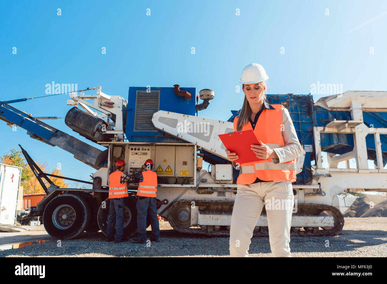 Bauingenieur Frau mit Zwischenablage vor steinbrecher Stockfoto