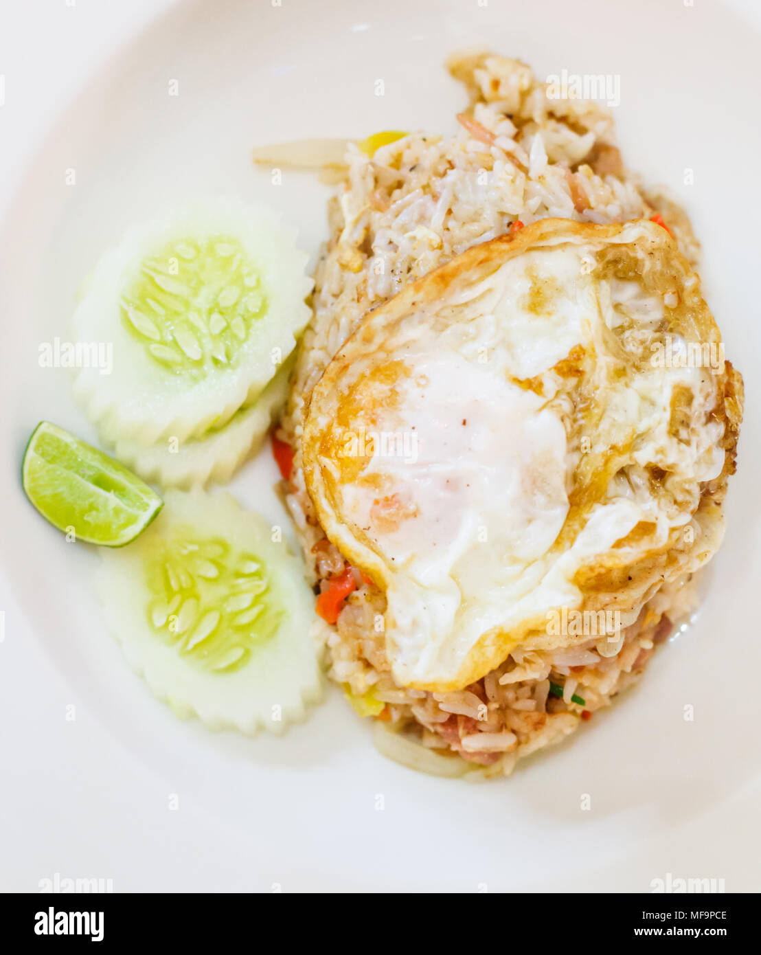 Selektiver Fokus Nahaufnahme traditionelle Thai asiatische Küche essen Menü: Leckere Thai fermentiert Schweinefleisch gebratener Reis mit Spiegelei oben garniert mit Zitrone Stockfoto