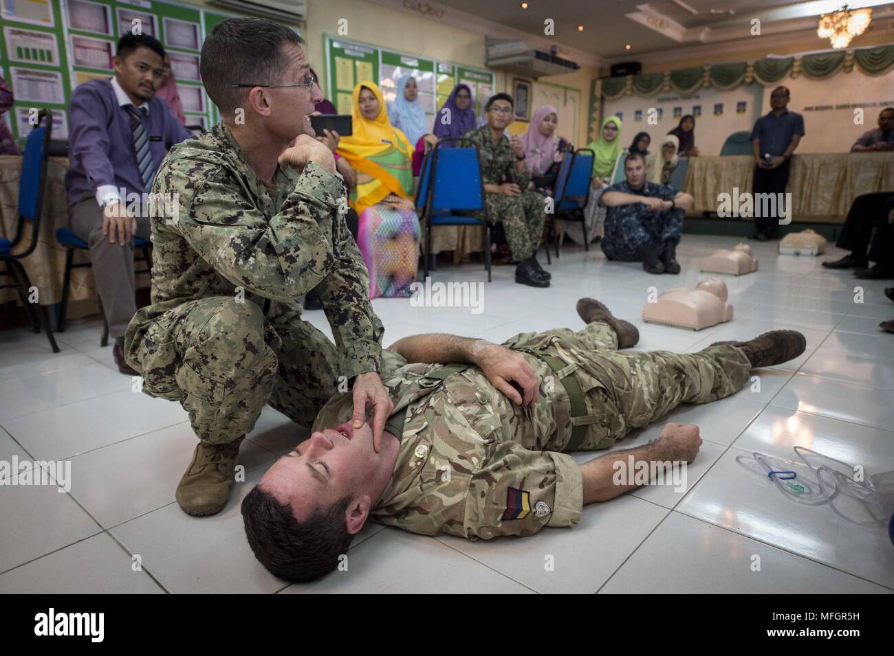 180424-N-MW 694-0153 Tawau, Malaysia (24. April 2018) Cmdr. Christopher Jack und Royal Army Medical Corps Cpl. Darren Phillips, zugeordnet zu den pazifischen Partnerschaft 2018 (PP18), zeigen die Reaktion auf einen Unfall während einer Erste Hilfe Ausbildung bei der SMK Balung secondary school gehalten, 24. April, 24. April 2018. PP18's Mission ist es, gemeinsam mit Gastgeber und Partner Nationen zu arbeiten regionaler Interoperabilität und Disaster Response Funktionen, erhöhen die Stabilität und Sicherheit in der Region zu stärken, und neue und dauerhafte Freundschaften in der gesamten indopazifischen Region fördern. Pazifische Partnerschaft, jetzt in seiner 1. Stockfoto