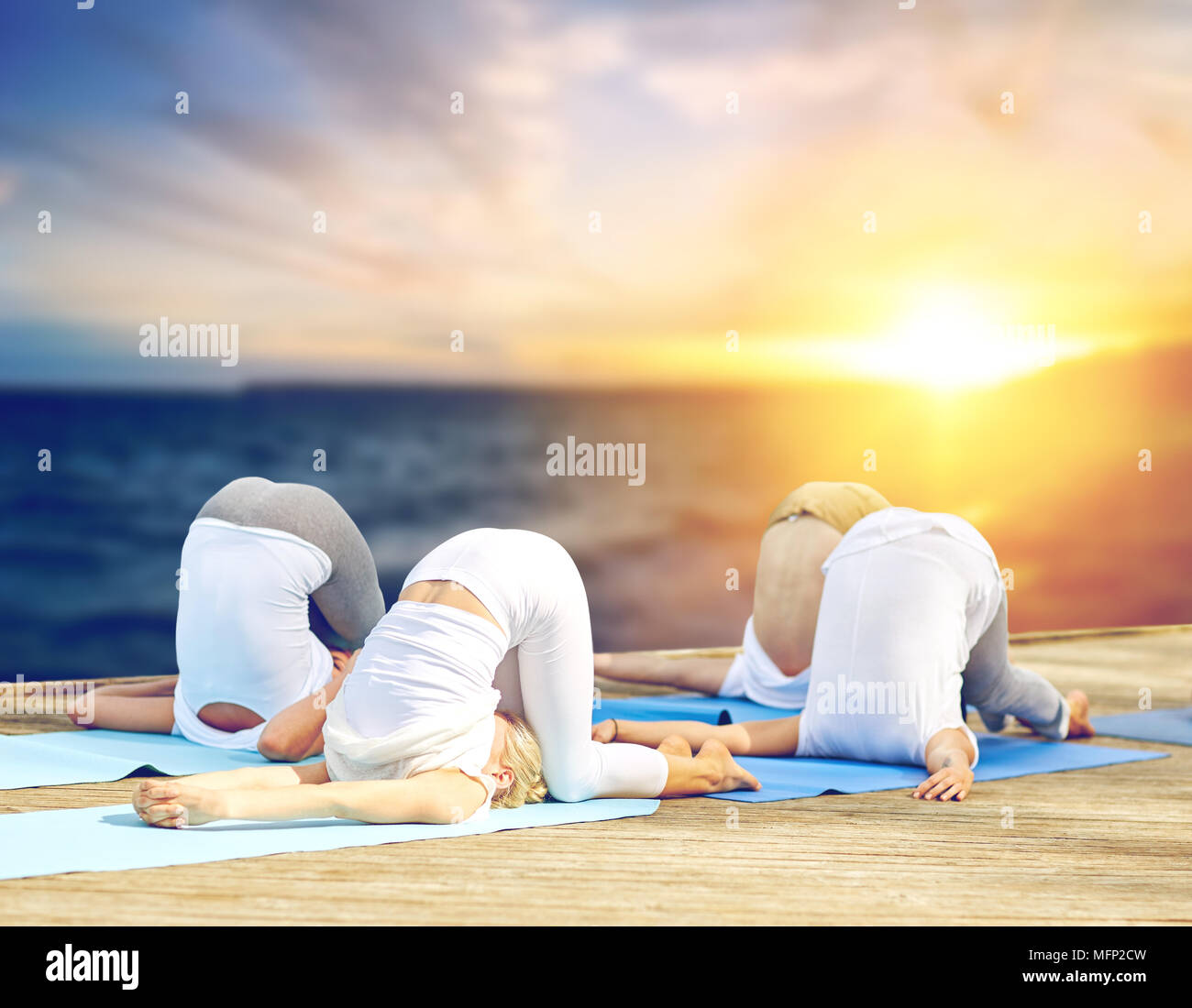 Gruppe von Menschen, die Yoga Druck stellen im Freien Stockfoto