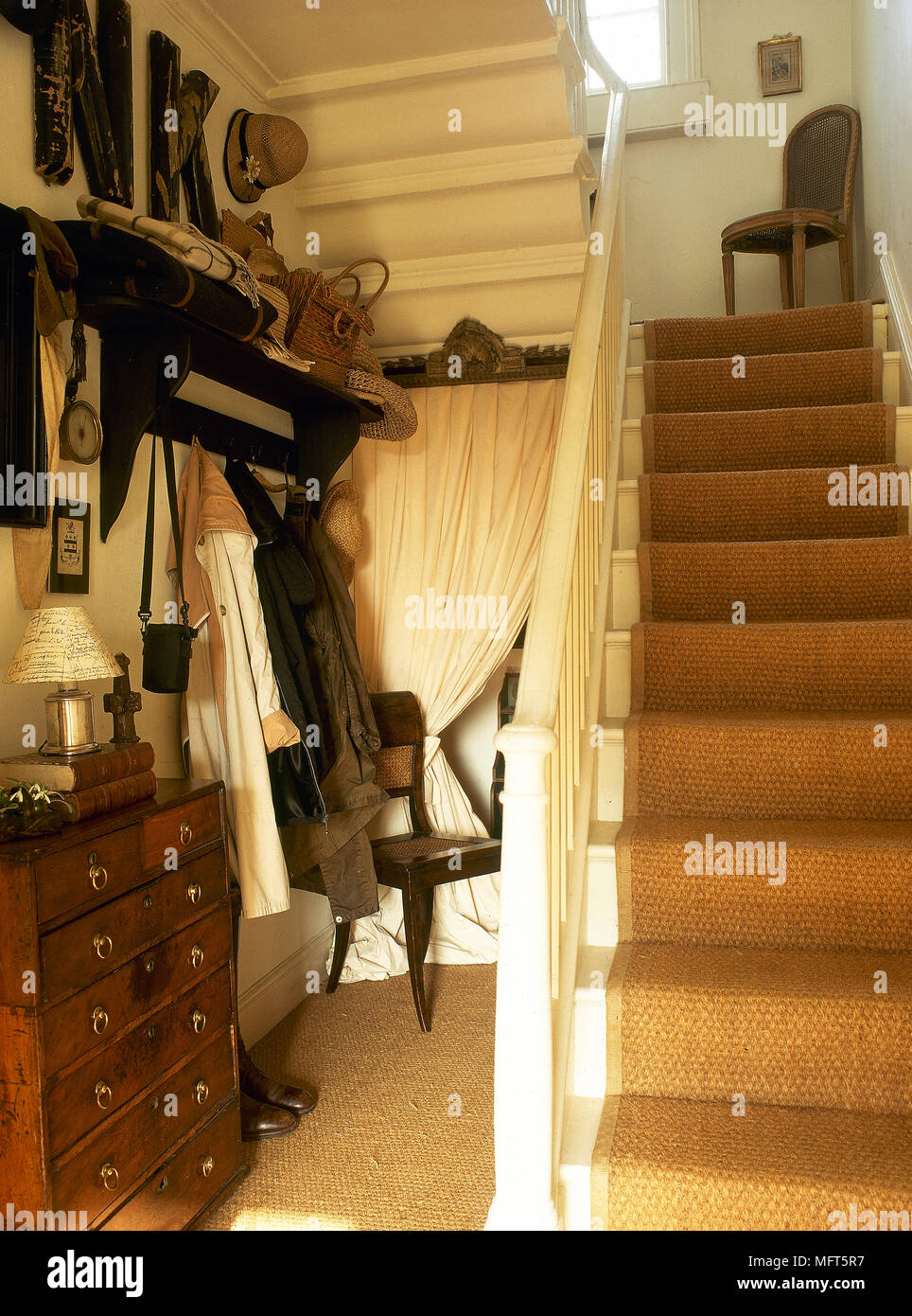 Ein Detail einer traditionellen Flur mit Treppe, Kommode, Garderobe  Stockfotografie - Alamy