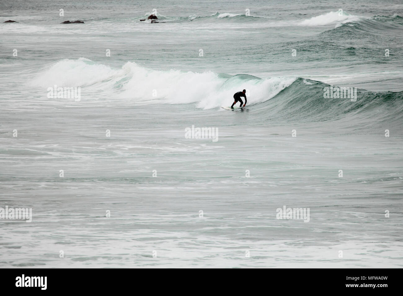Ein Surfer reitet eine Welle an der Küste von Kalifornien Stockfoto