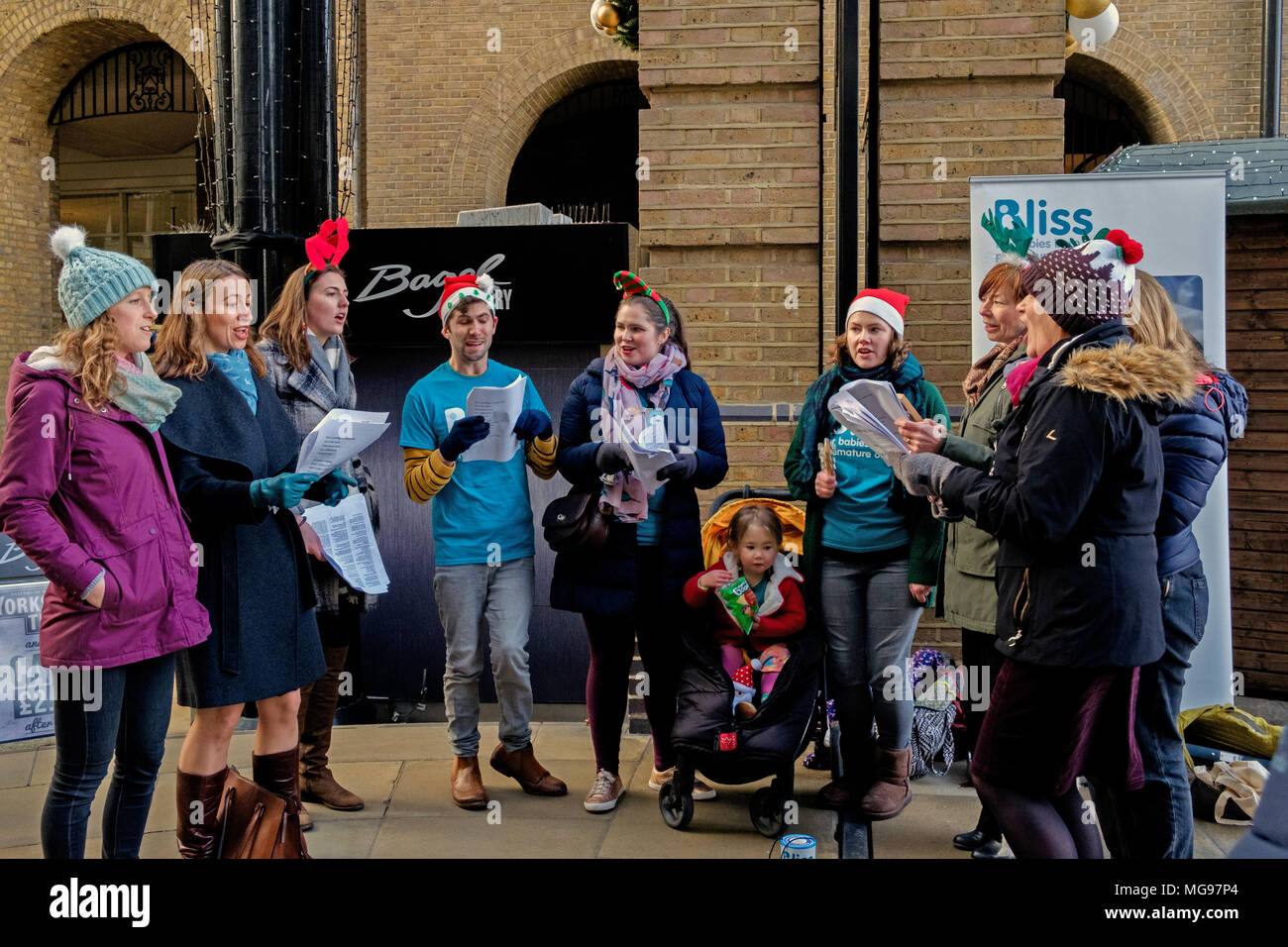 Neun freiwilligen singen Weihnachtslieder an der London Bridge Station Fonds & Bewusstsein für Glück in der Liebe zu erhöhen. Stockfoto