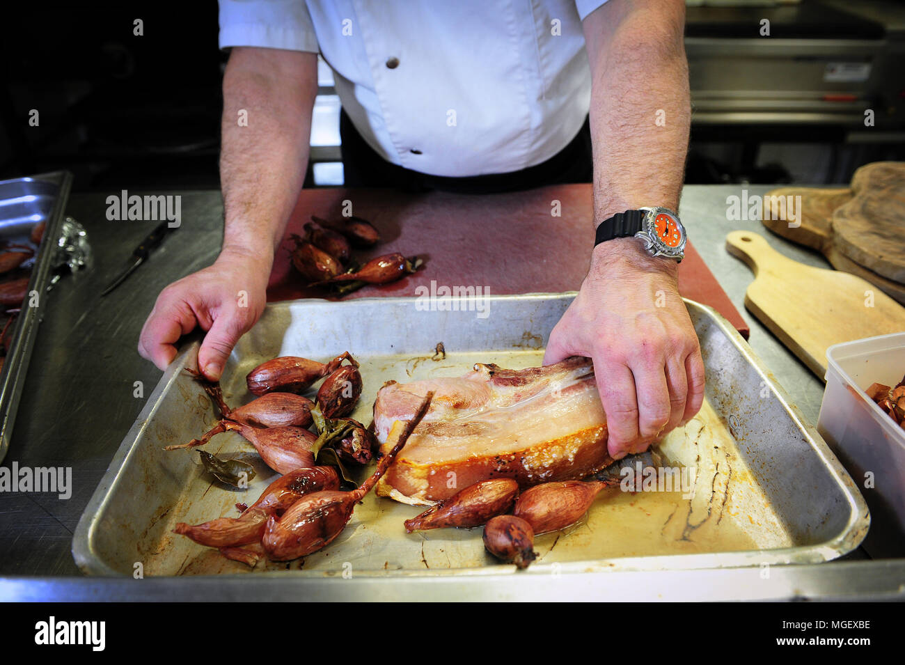 Essen Vorbereitung - karamellisierten Schweinefleisch mit Cherrueix schalotten von La Table du Marais Restaurant hacken, La Fresnais, Frankreich Stockfoto