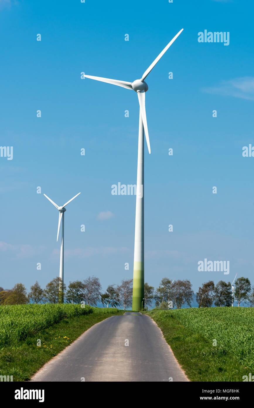 Windkraftanlagen und der Landstraße in Deutschland gesehen Stockfoto
