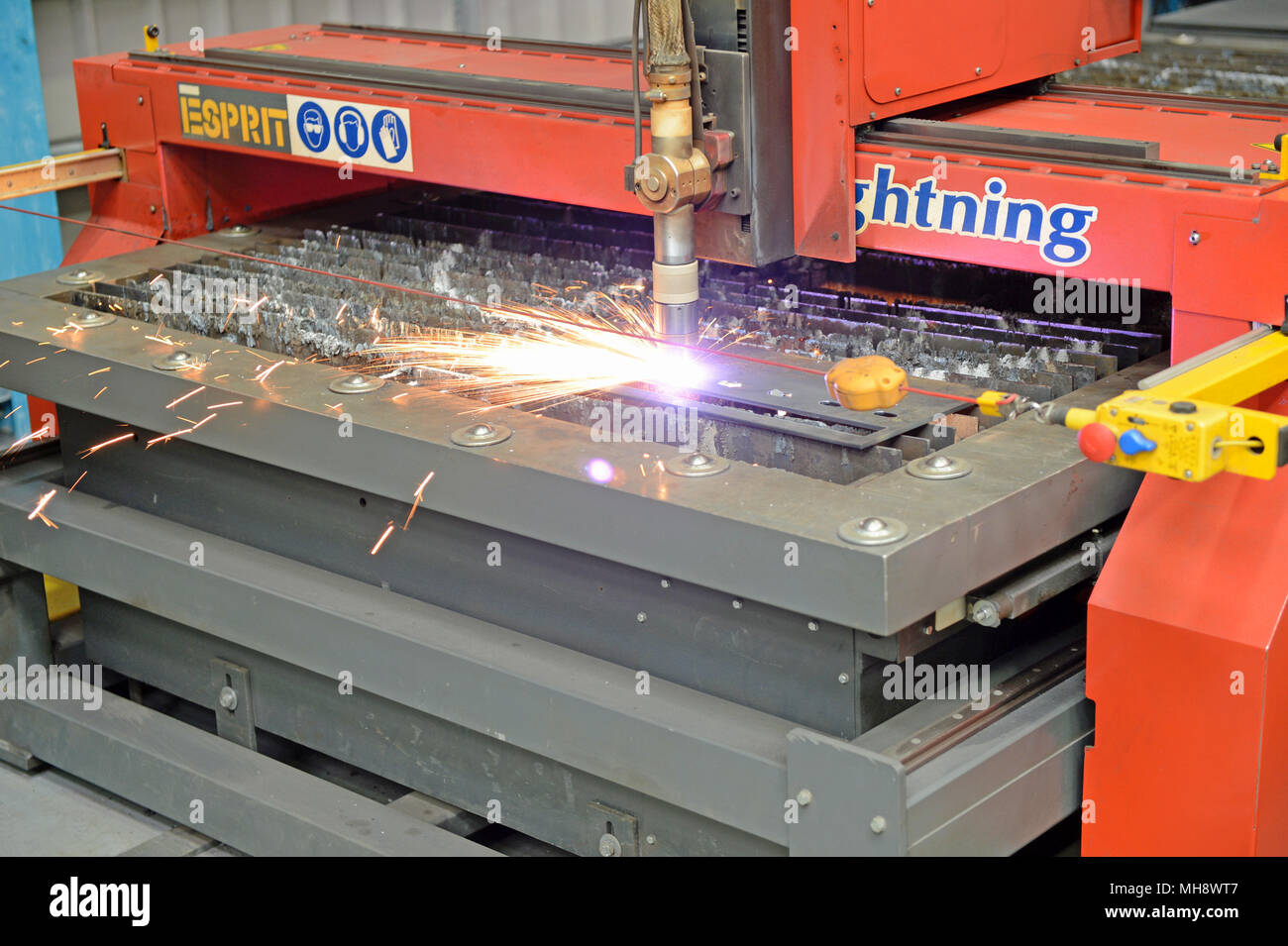 Mann bei der Arbeit auf einer metallenen Plasmaschneidemaschine in einer Werkstatt Stockfoto