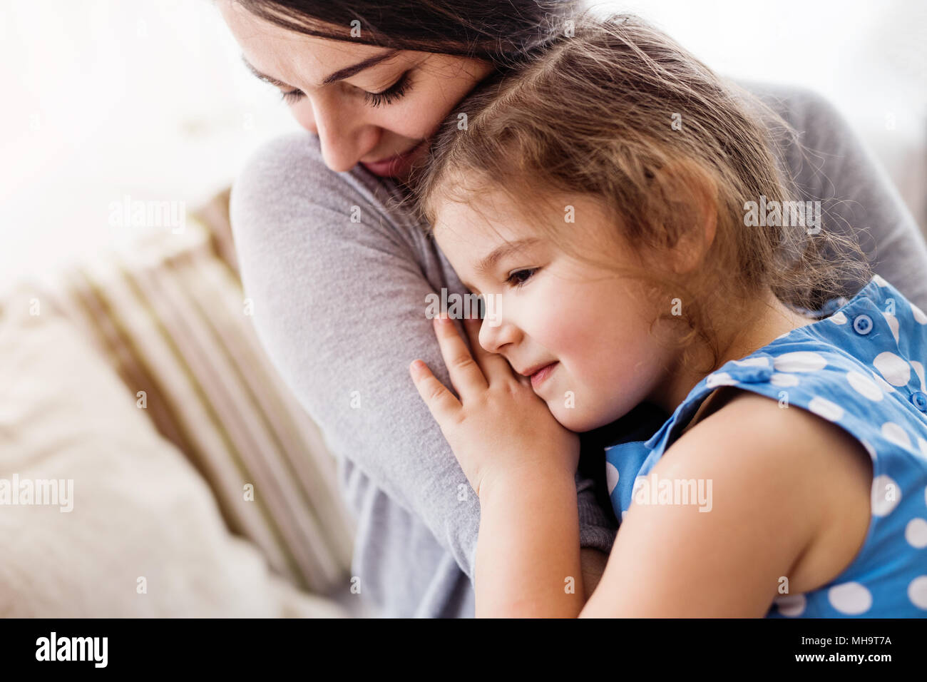 Junge Mutter mit einem kleinen Mädchen zu Hause. Stockfoto